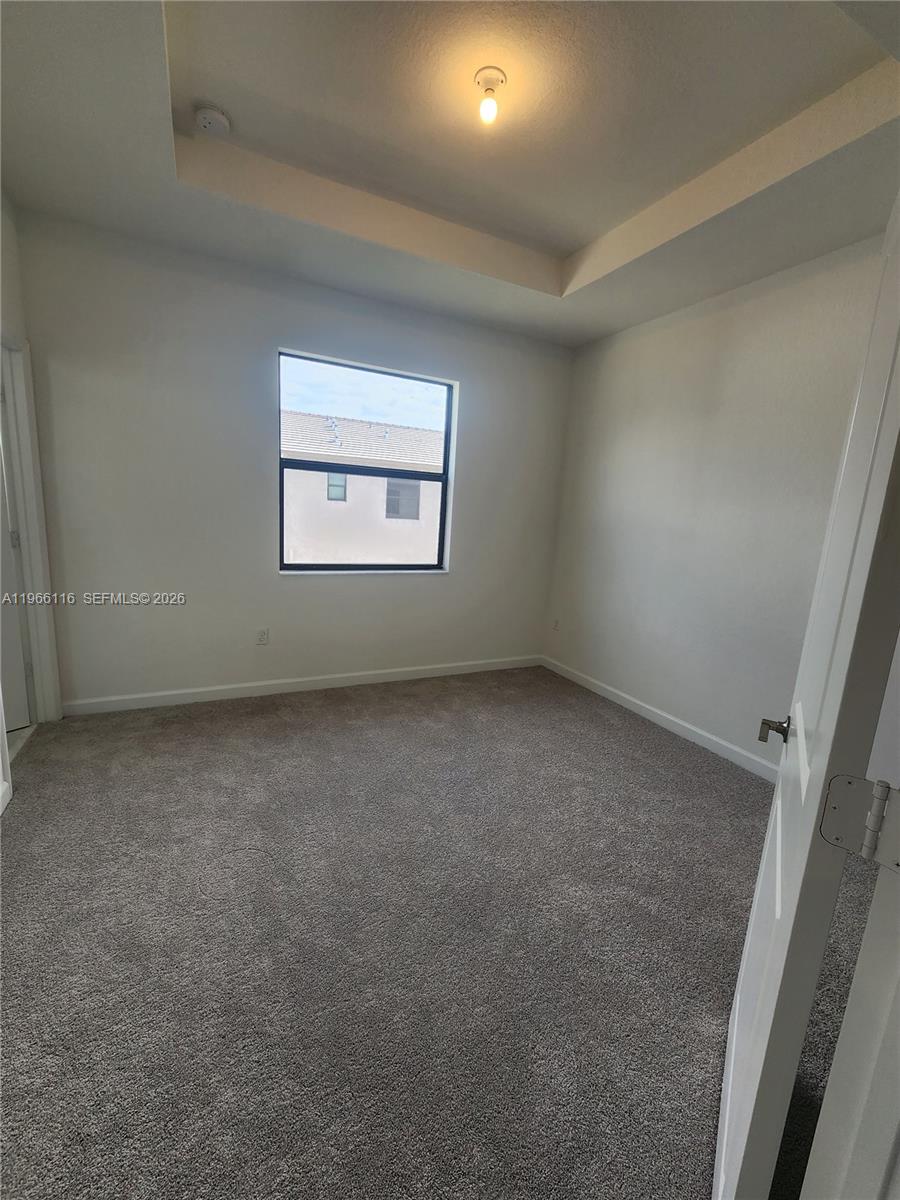 23331 Southwest 128th Avenue, Unit 23331 Homestead, FL 33032 - Photo 7 of 16 an empty room with a window