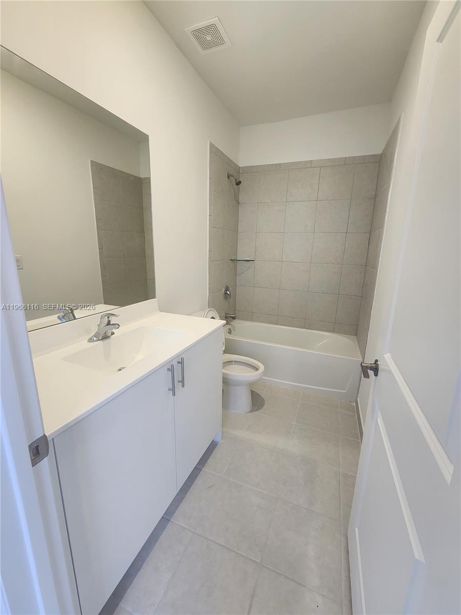23331 Southwest 128th Avenue, Unit 23331 Homestead, FL 33032 - Photo 9 of 16 a bathroom with a sink a toilet and shower