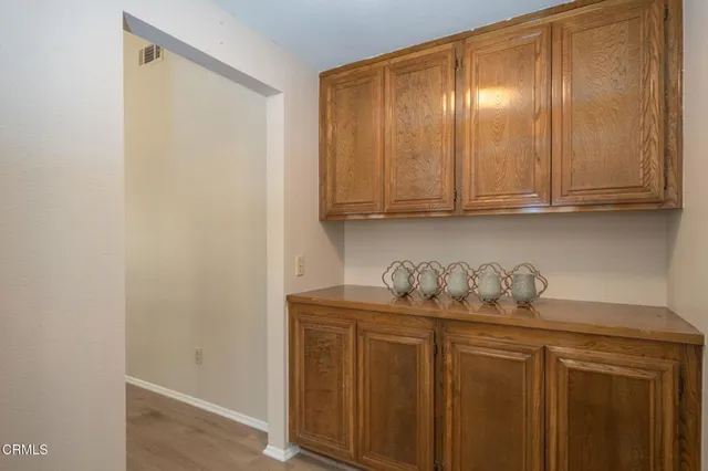 a kitchen with a refrigerator and cabinets