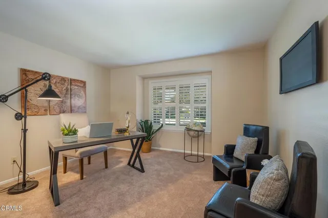 a work room with furniture and a flat screen tv
