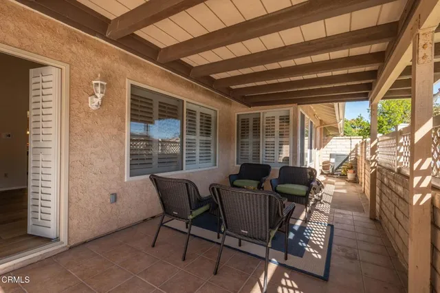 a view of a porch with furniture and a table