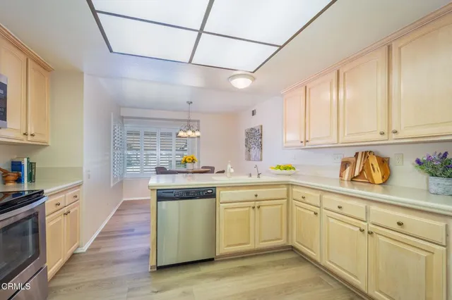 a kitchen with a sink window and cabinets