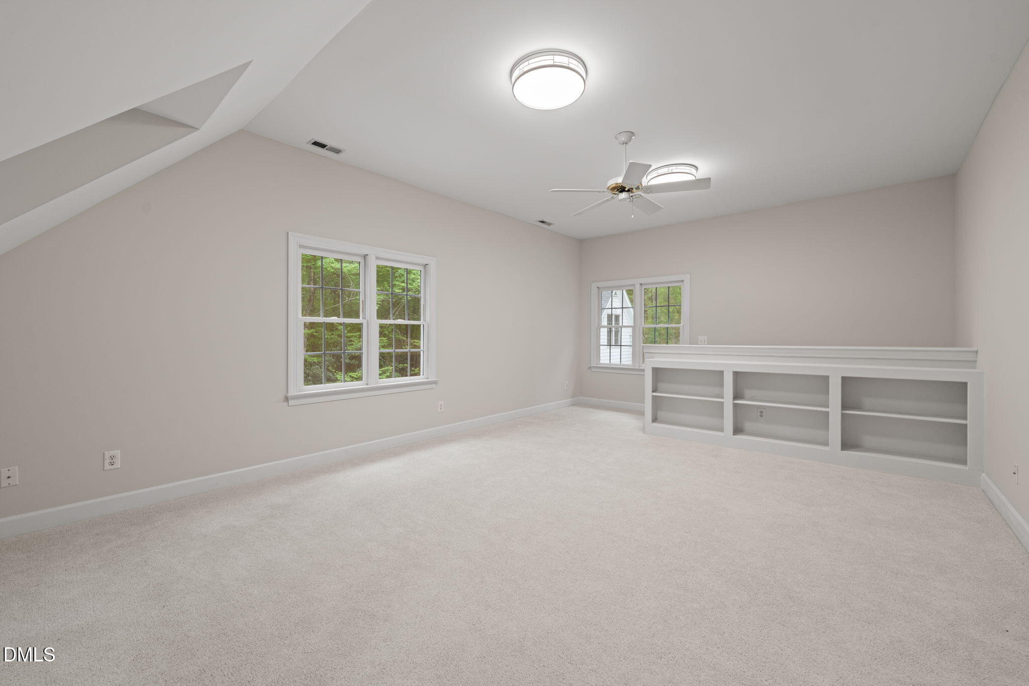 5809 Stone Spring Road Raleigh, NC 27613 - Photo 33 of 54 an empty room with chandelier fan and windows