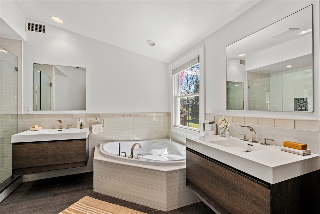 22 Crestview Road Belmont, MA 02478 - Photo 16 of 36 a bathroom with a double vanity sink mirror and bathtub