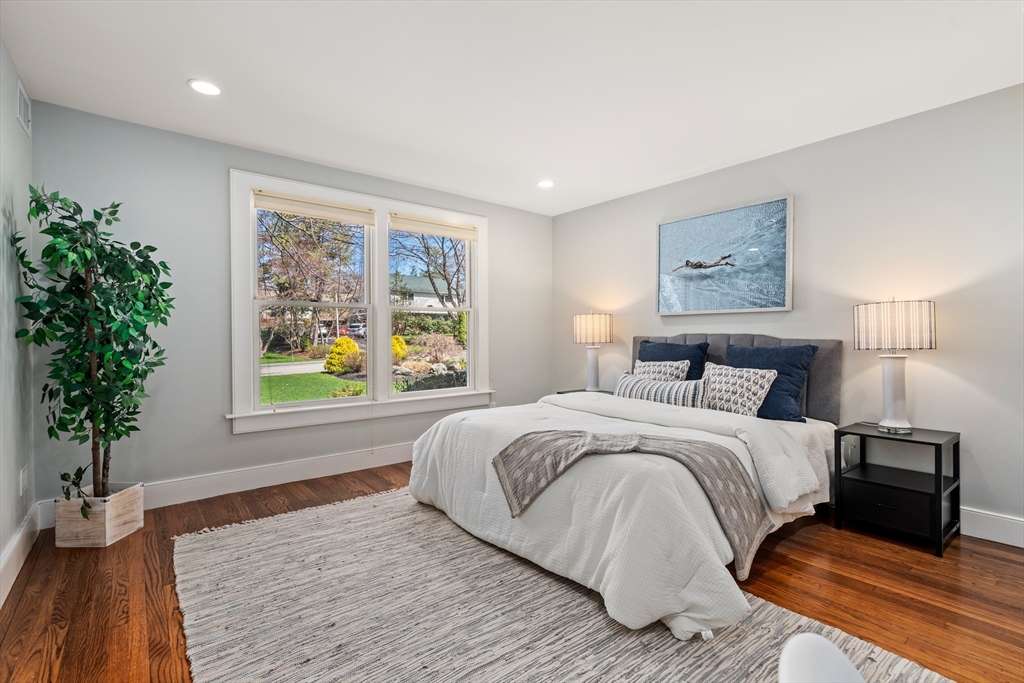 22 Crestview Road Belmont, MA 02478 - Photo 18 of 36 a bedroom with a large bed and a potted plant