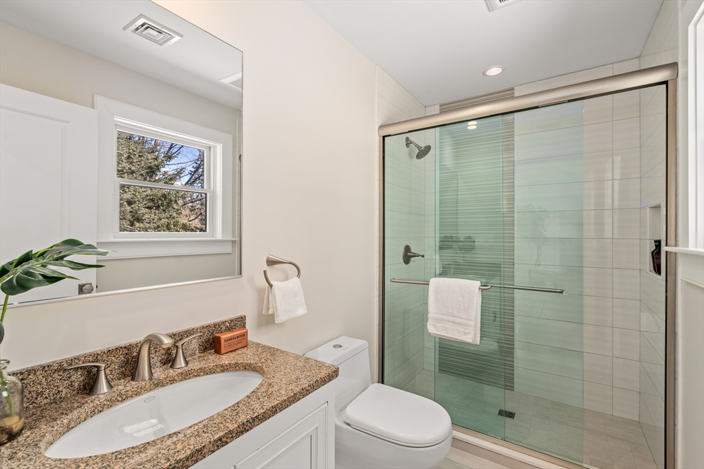 22 Crestview Road Belmont, MA 02478 - Photo 25 of 36 a bathroom with a granite countertop sink toilet and shower