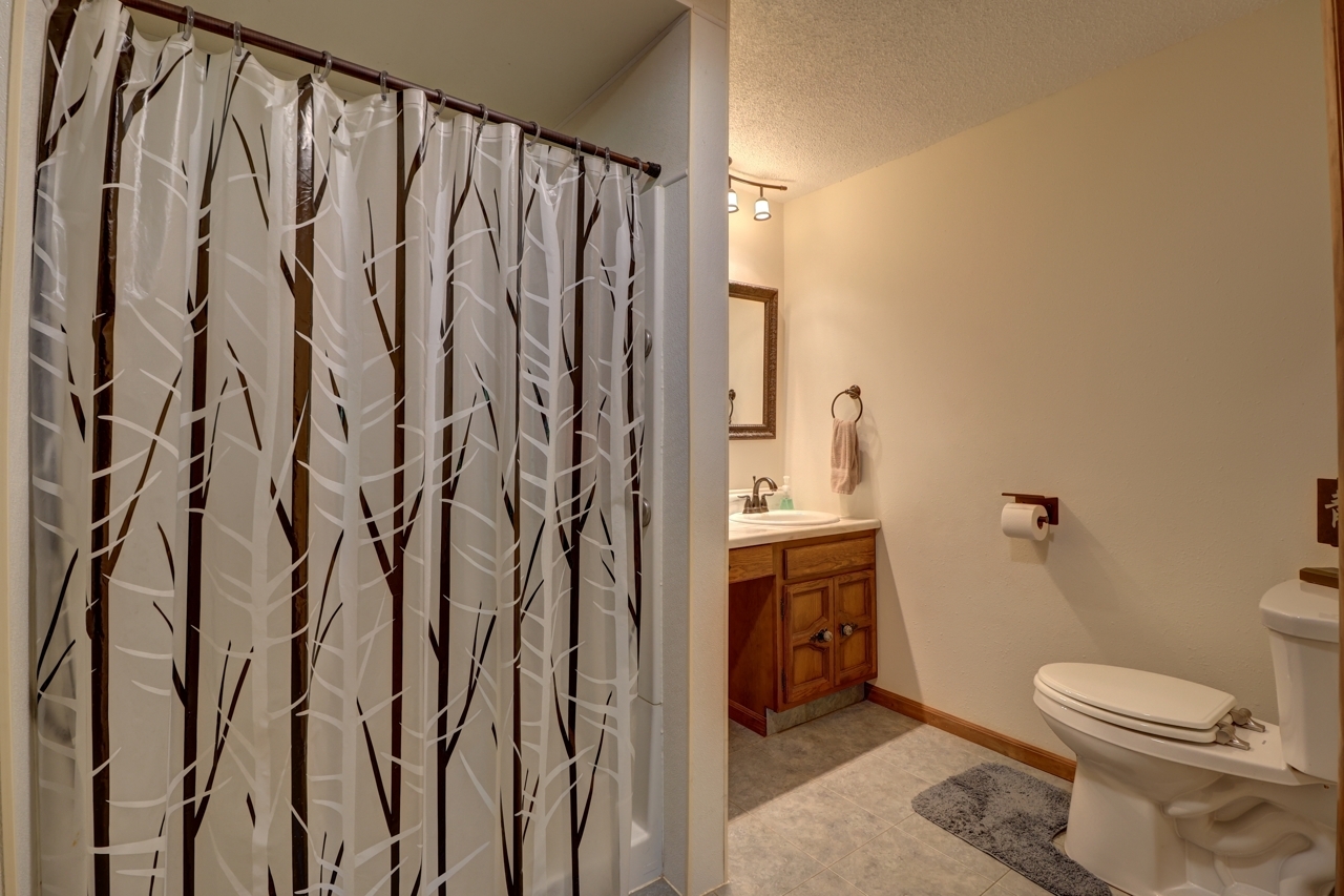 14755 Fenton Road Morrison, IL 61270 - Photo 15 of 34 a bathroom with a shower curtain and a sink