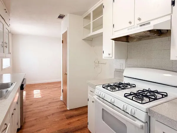 a kitchen with a stove and a refrigerator
