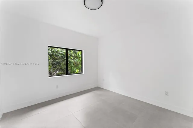 a view of an empty room with windows