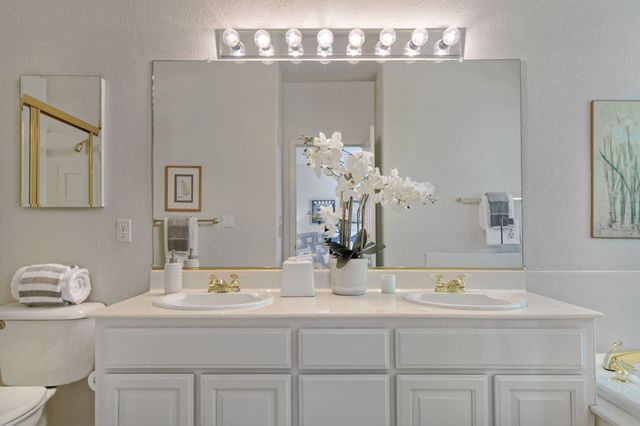 a bathroom with a sink double vanity and a mirror