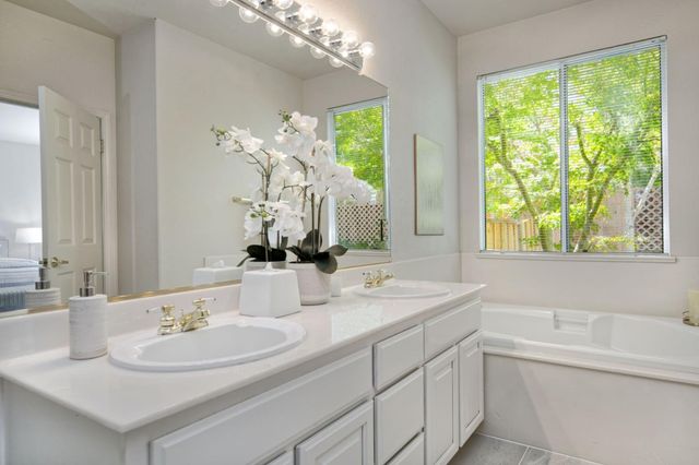 a bathroom with a double vanity sink and a mirror