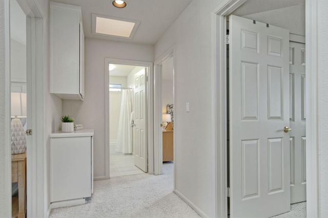 a view of a kitchen with white cabinets