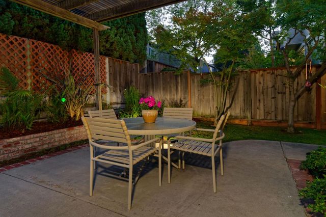 a view of a backyard with table and chairs