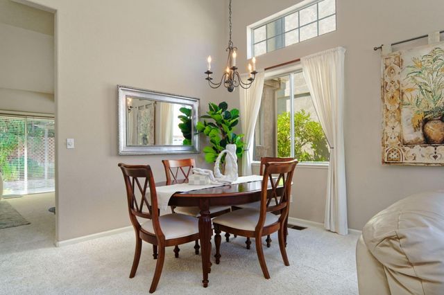 a view of a dining room with furniture and a window