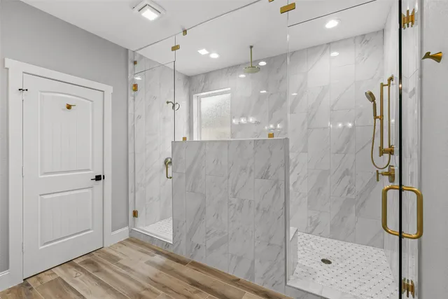a bathroom with a granite countertop shower