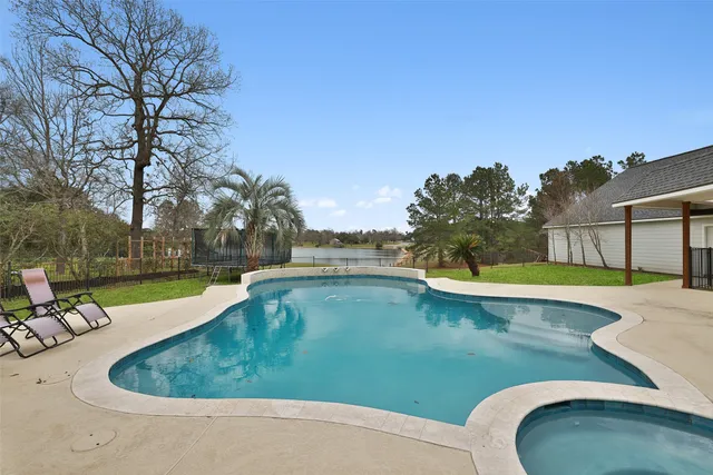 a view of a house with swimming pool and a yard