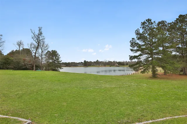 a view of a house with a yard and pool