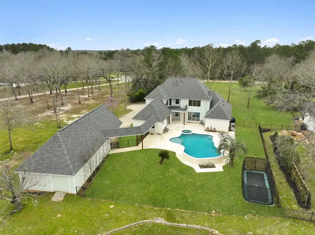 an aerial view of a house with a swimming pool