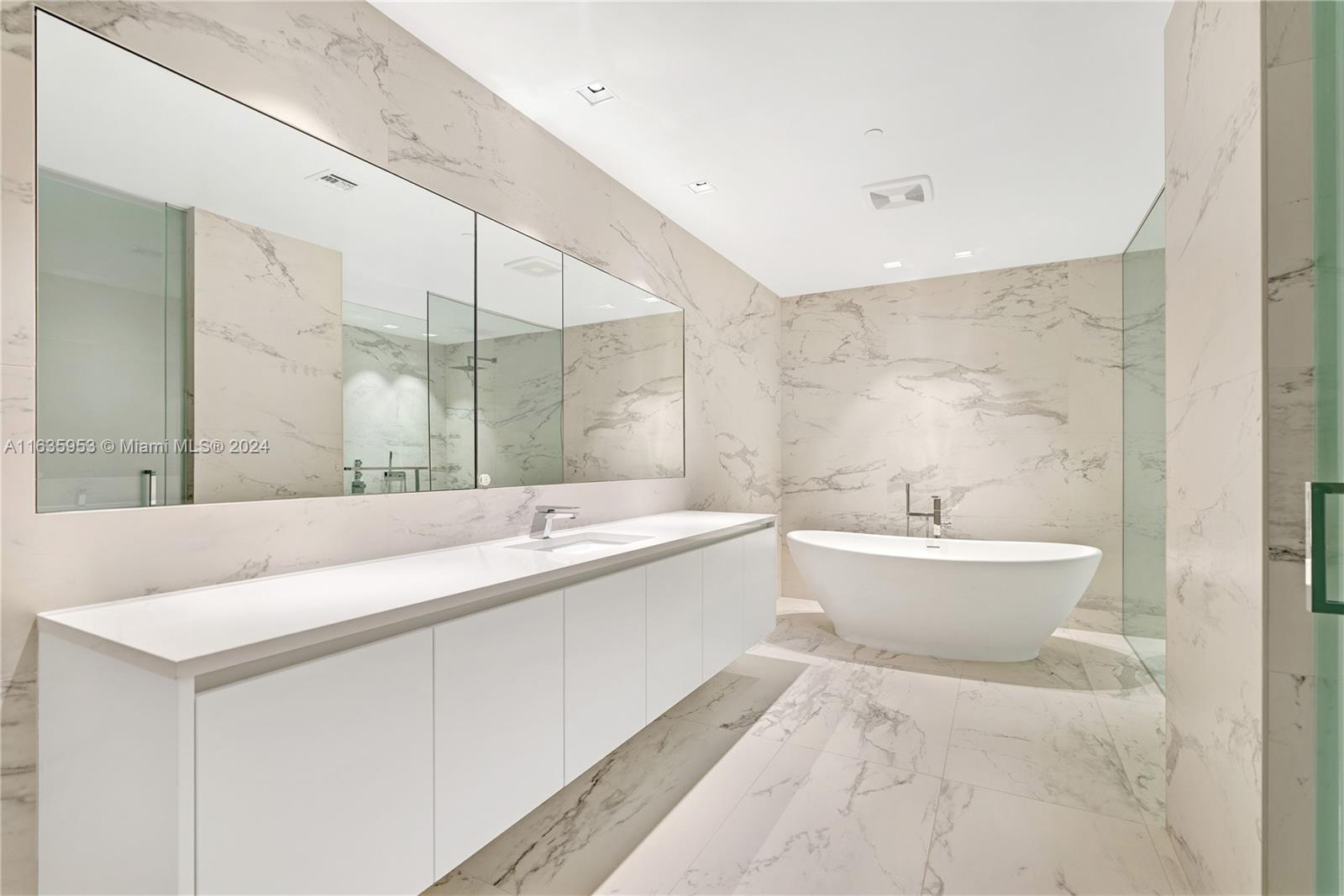 1000 Biscayne Boulevard, Unit 1202 Miami, FL 33132 - Photo 12 of 23 a bathroom with a tub sink and mirror