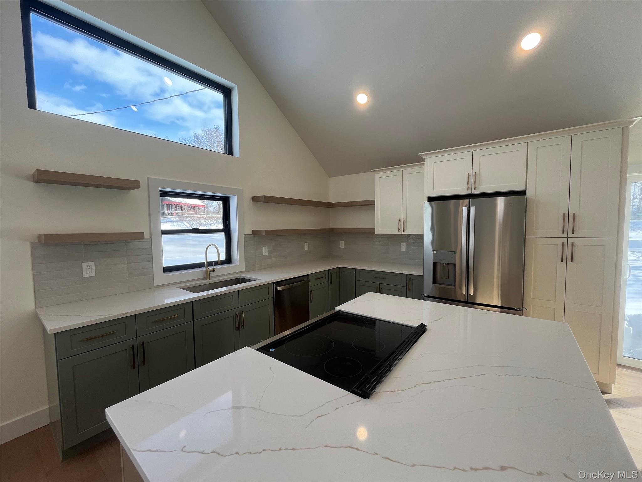 119 Bakertown Road Accord, NY 12404 - Photo 6 of 17 Kitchen featuring open shelves, light stone counters, appliances with stainless steel finishes, high vaulted ceiling, and tasteful backsplash