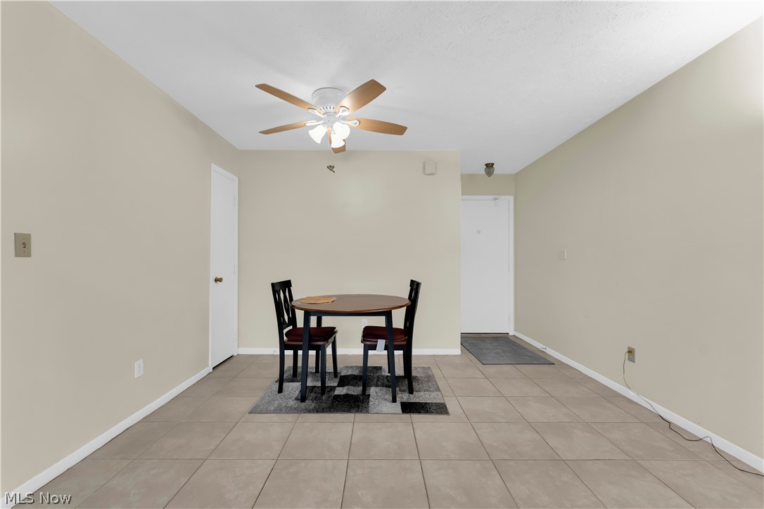 985 Canyon View Road, Unit 108D Northfield, OH 44067 - Photo 3 of 18 Dining area featuring light tile patterned floors and a ceiling fan