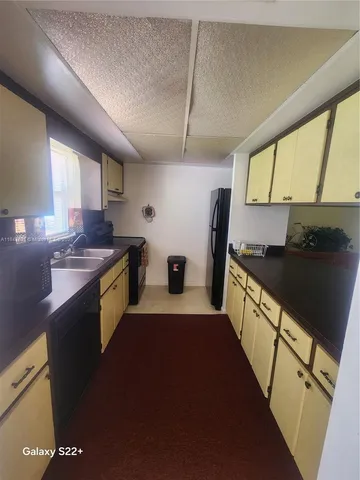 a kitchen with sink a stove and refrigerator