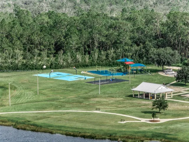 a aerial view of a house with a yard and lake view