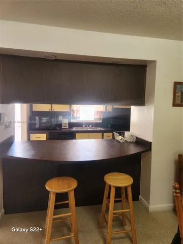 a kitchen with a table and chairs in it