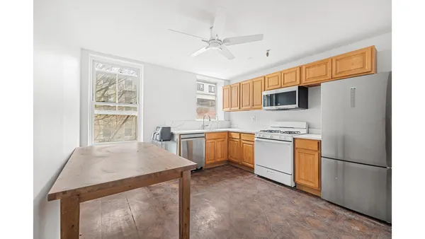 a kitchen with white cabinets and white appliances