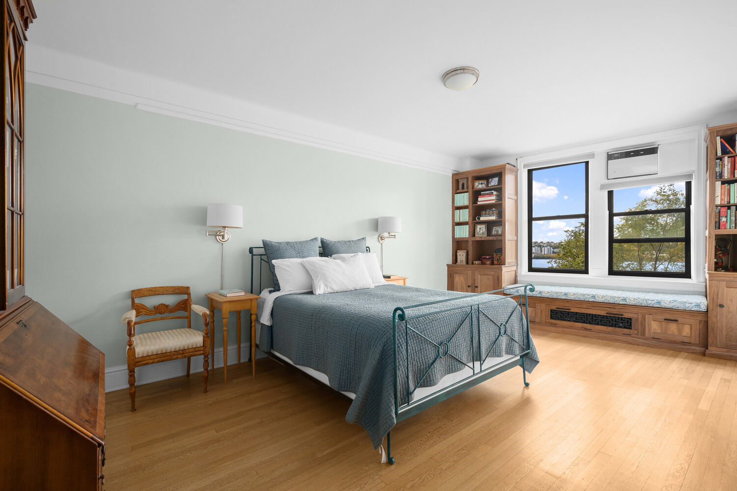 395 Riverside Drive, Unit 7C Manhattan, NY 10025 - Photo 4 of 10 a bedroom with a bed and a large window