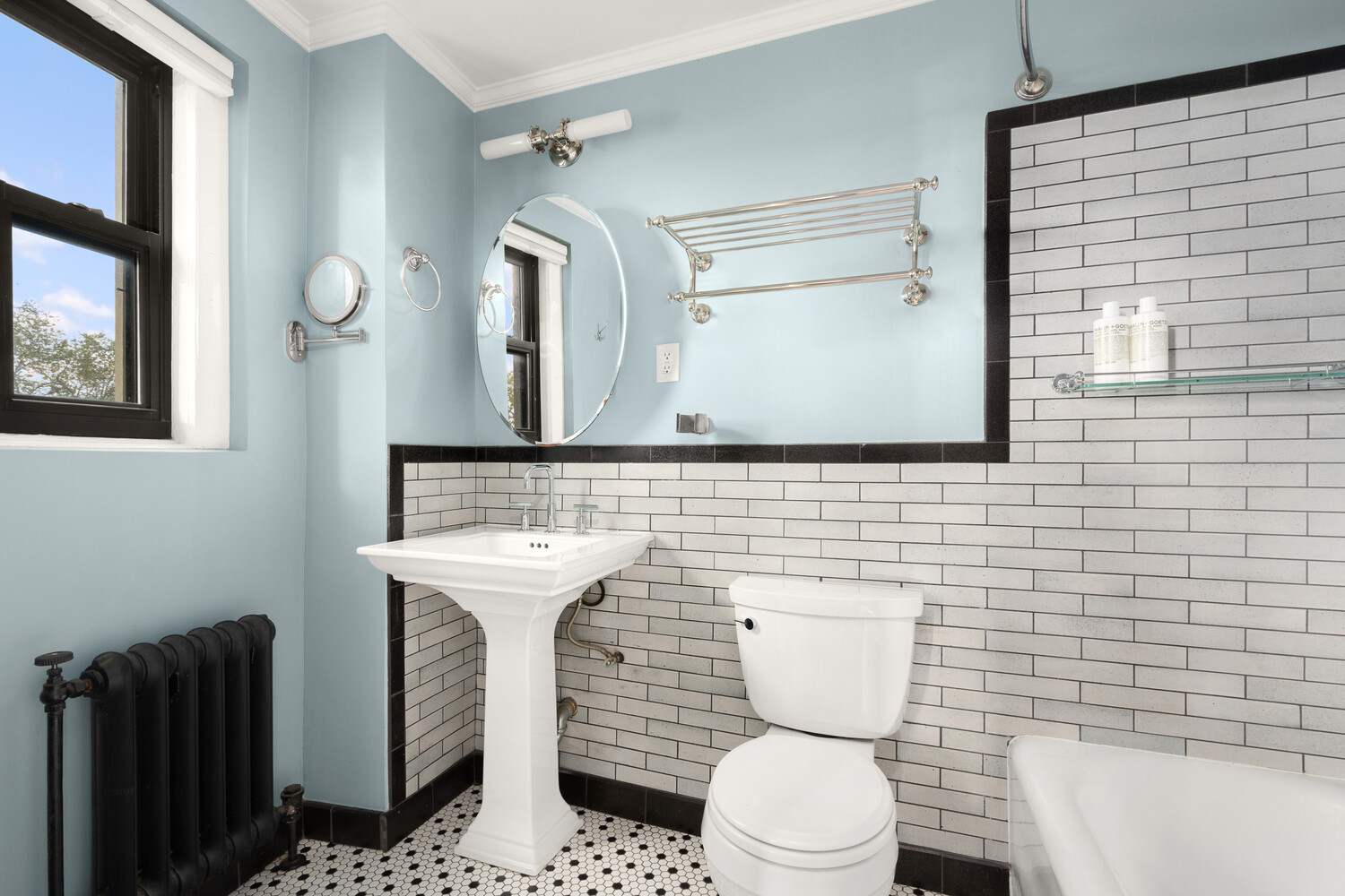 395 Riverside Drive, Unit 7C Manhattan, NY 10025 - Photo 5 of 10 a bathroom with a toilet a sink and mirror