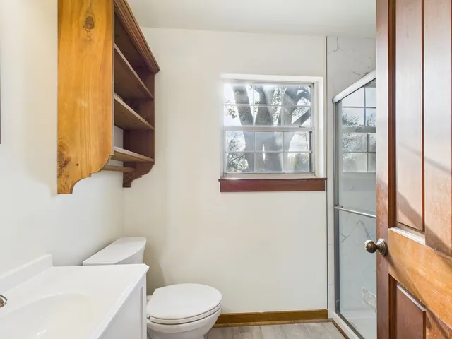 a bathroom with a toilet a sink and a shower