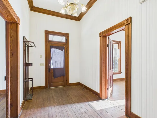 a view of a hallway with wooden floor and a hallway