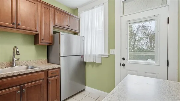 a kitchen with stainless steel appliances granite countertop a refrigerator and a sink