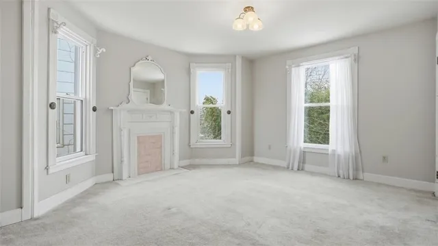 an empty room with windows and closet