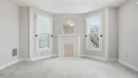 an empty room with windows and closet