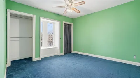 an empty room with chandelier fan