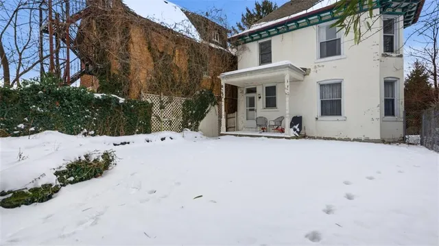 a view of a house with snow on the road