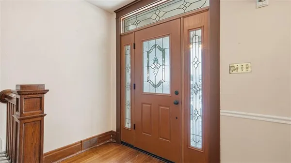 a view of hallway with wooden floor