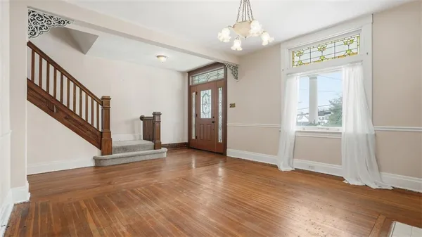 wooden floor in an empty room with a window and wooden floor