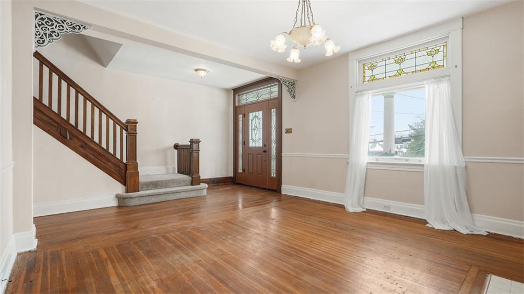 2129 Vodeli Street Pittsburgh, PA 15216 - Photo 8 of 35 wooden floor in an empty room with a window and wooden floor
