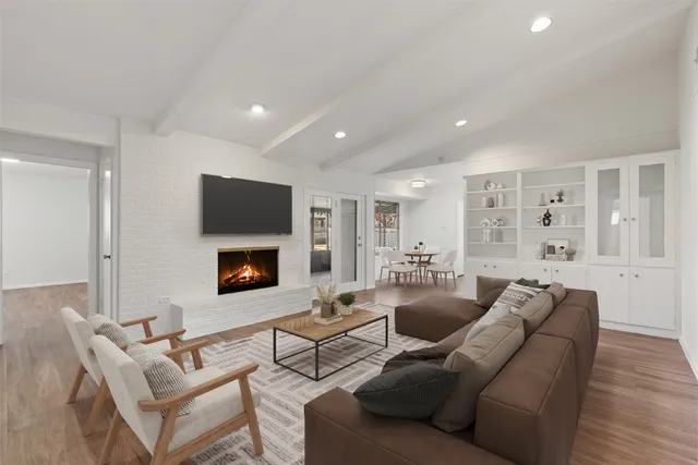 a kitchen with cabinets appliances and a wooden floor