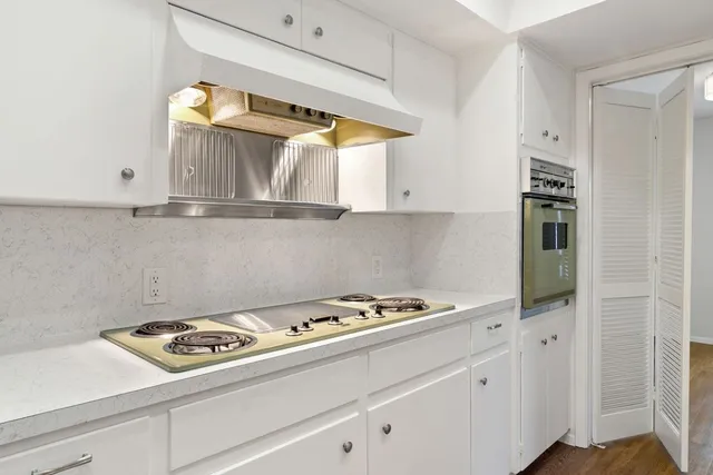 a view of a backyard with table and chairs and wooden fence