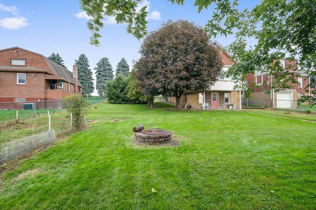 1072 Roup Avenue Brackenridge, PA 15014 - Photo 16 of 18 Flat, fenced in backyard with fire pit and garden.