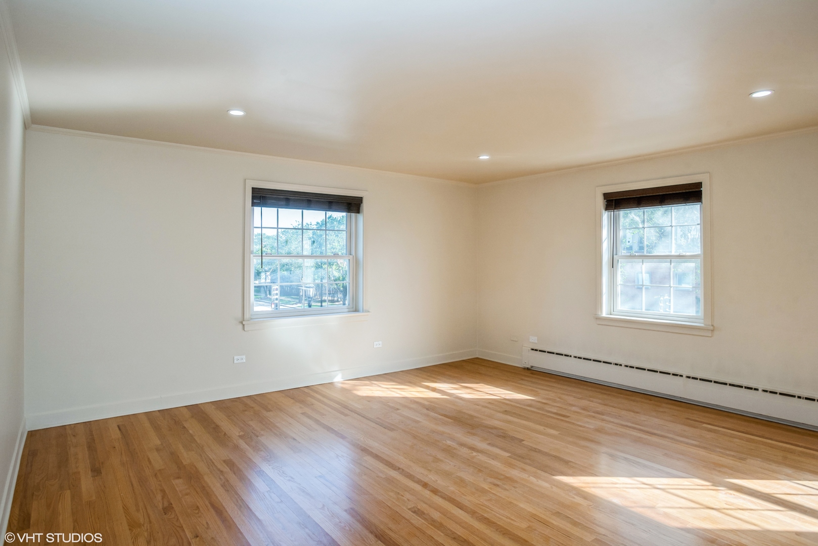 348 Ridge Avenue, Unit 2 Evanston, IL 60202 - Photo 2 of 16 an empty room with wooden floor and windows
