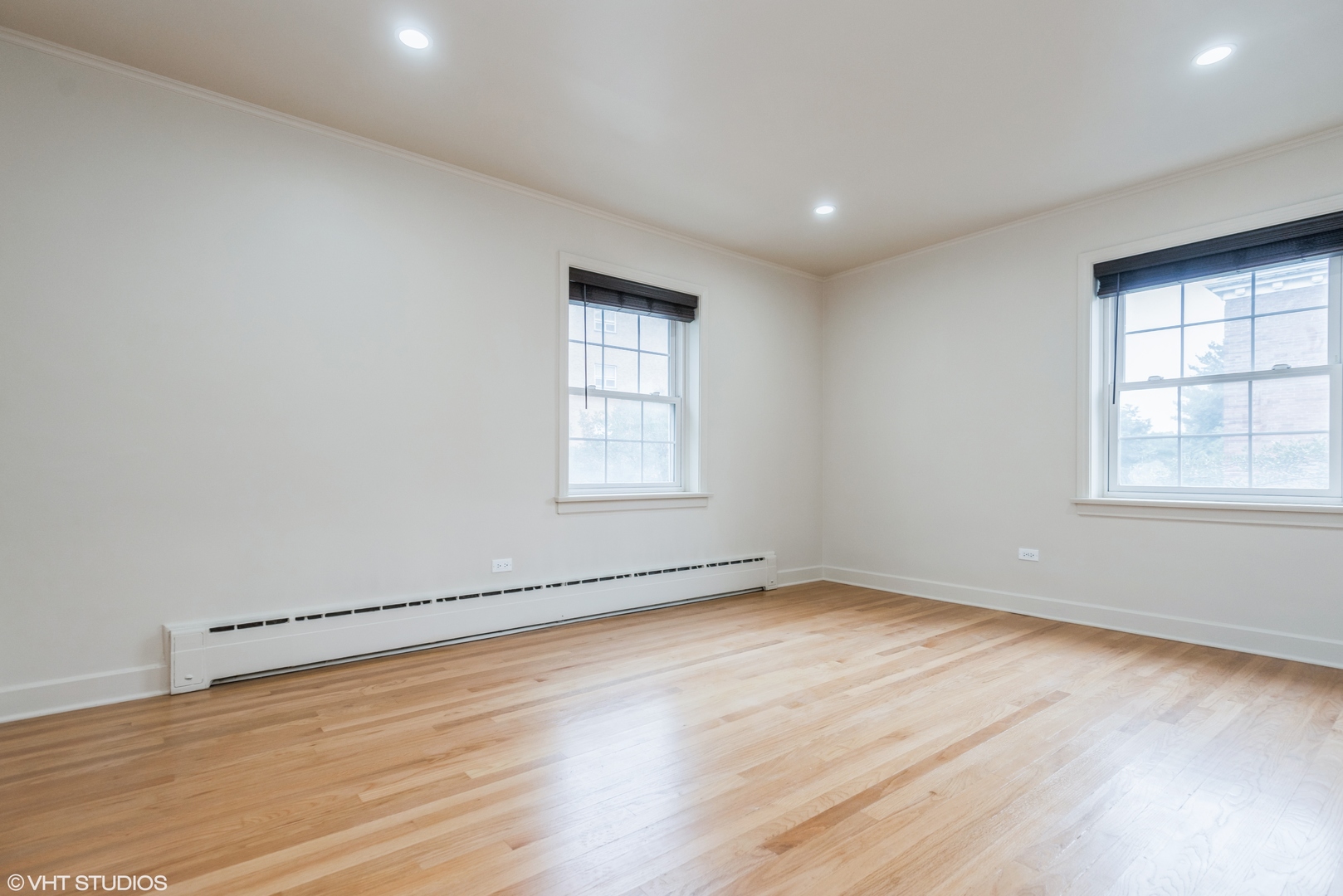 348 Ridge Avenue, Unit 2 Evanston, IL 60202 - Photo 11 of 16 an empty room with wooden floor and windows