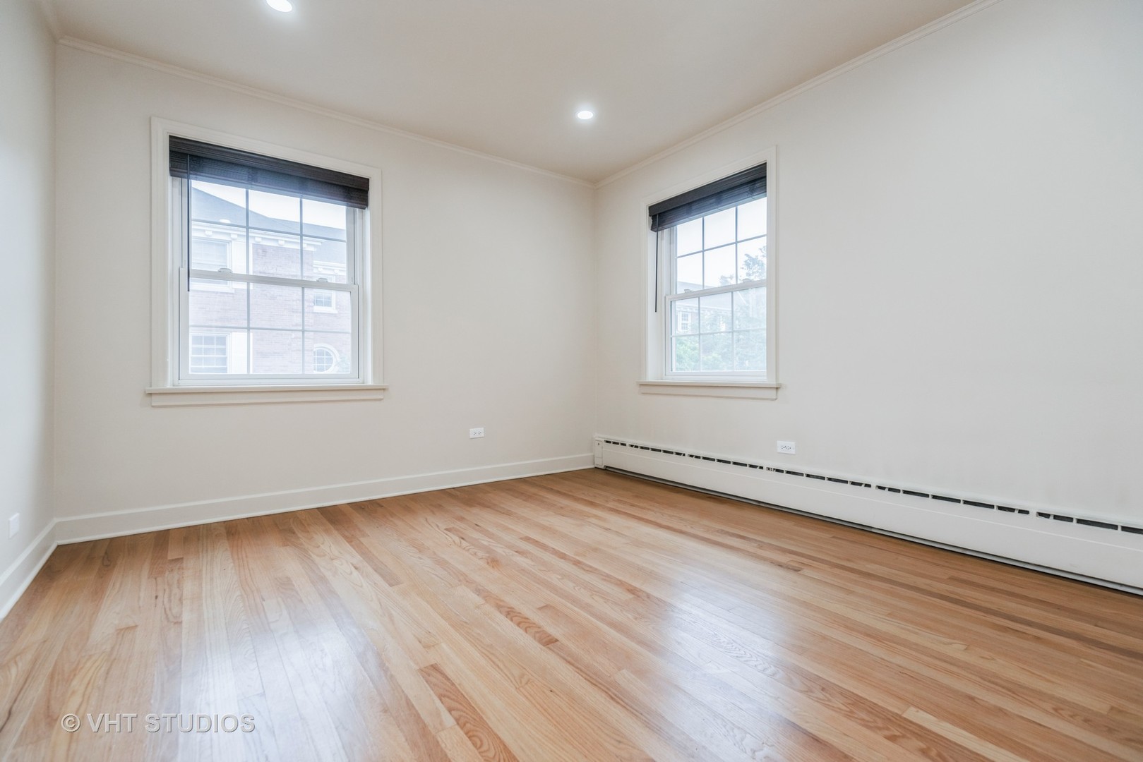 348 Ridge Avenue, Unit 2 Evanston, IL 60202 - Photo 13 of 16 an empty room with wooden floor and windows