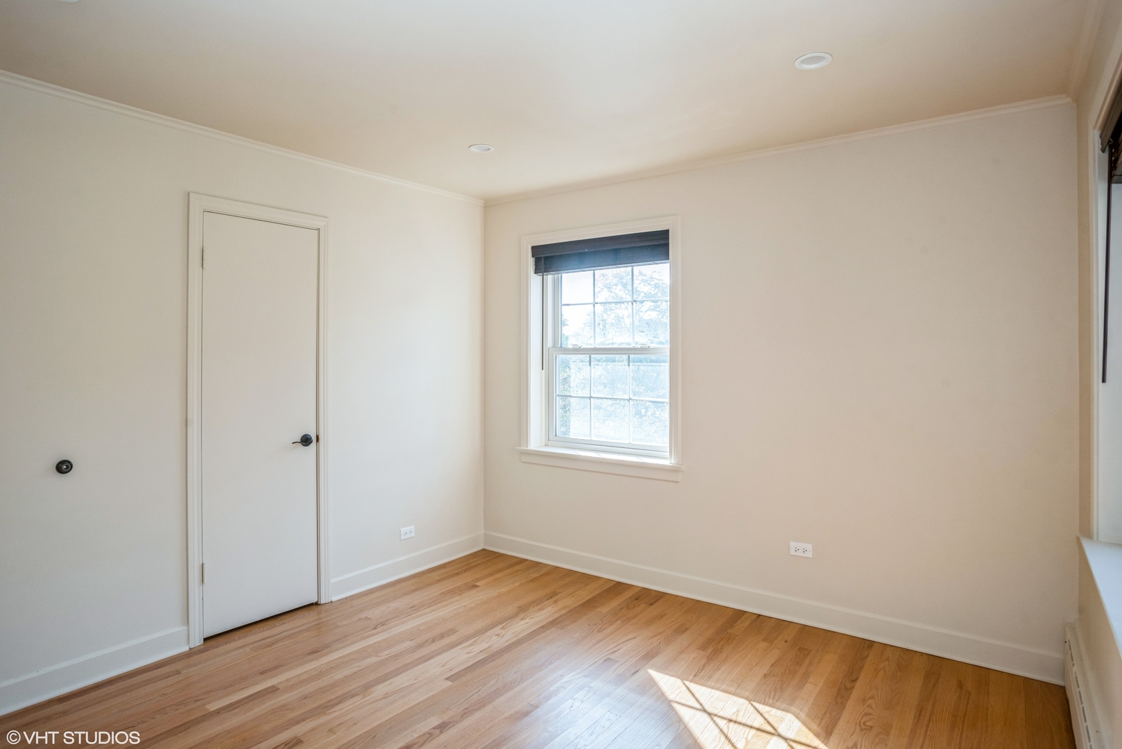 348 Ridge Avenue, Unit 2 Evanston, IL 60202 - Photo 14 of 16 an empty room with wooden floor and windows