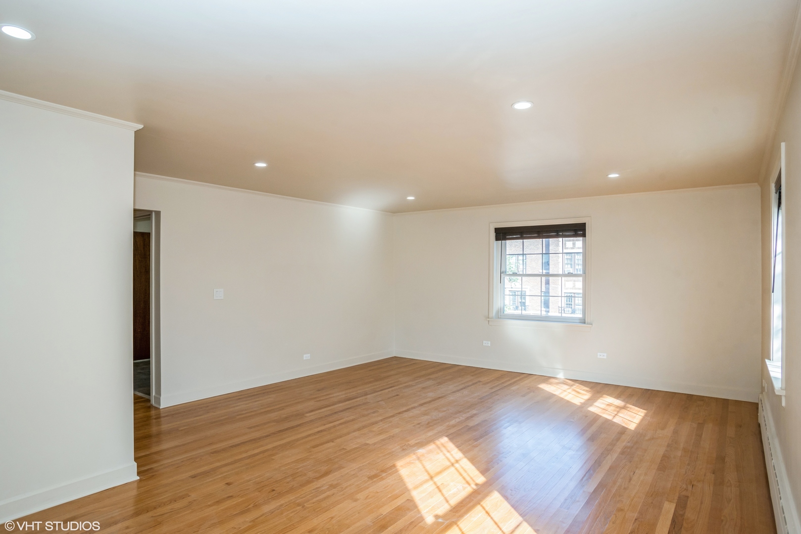 348 Ridge Avenue, Unit 2 Evanston, IL 60202 - Photo 3 of 16 a view of empty room with wooden floor and fan