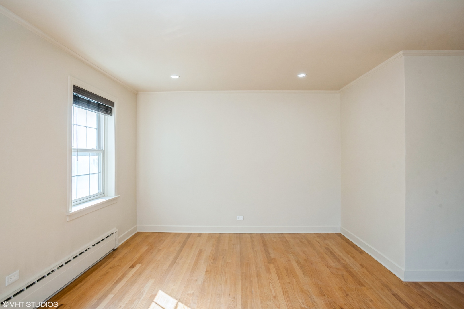 348 Ridge Avenue, Unit 2 Evanston, IL 60202 - Photo 6 of 16 an empty room with wooden floor and windows